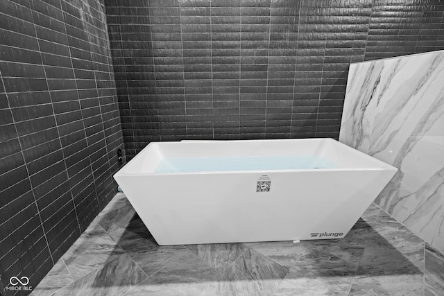 11101 Hawthorn Rdg, Fishers, IN 46037 - full bath with marble finish floors, a soaking tub, and tile walls