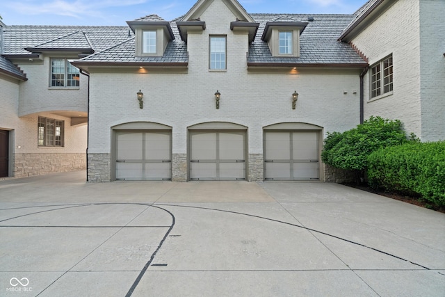 11101 Hawthorn Rdg, Fishers, IN 46037 - view of front of property with a high end roof, a garage, driveway, and brick siding