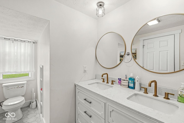 2 S 25th Ave, Beech Grove, IN 46107 - full bath with double vanity, a textured ceiling, toilet, and tile patterned flooring