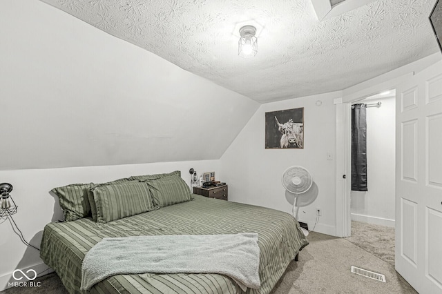 2 S 25th Ave, Beech Grove, IN 46107 - bedroom featuring carpet floors, lofted ceiling, baseboards, and a textured ceiling