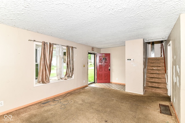 6238 E 43rd St, Indianapolis, IN 46226 - foyer entrance with carpet, stairway, baseboards, and a textured ceiling