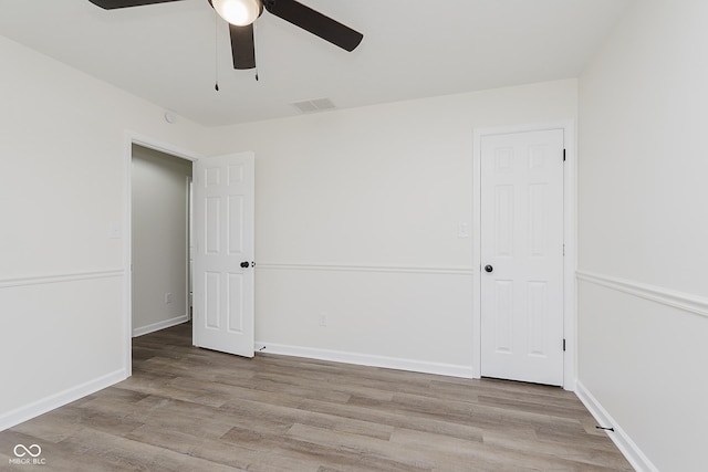 374 Pomona Ct, Greenfield, IN 46140 - unfurnished bedroom featuring wood finished floors, a ceiling fan, and baseboards