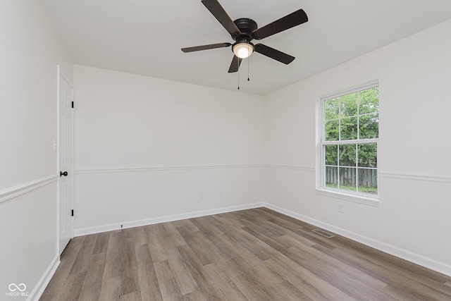 374 Pomona Ct, Greenfield, IN 46140 - empty room with wood finished floors, a ceiling fan, and baseboards