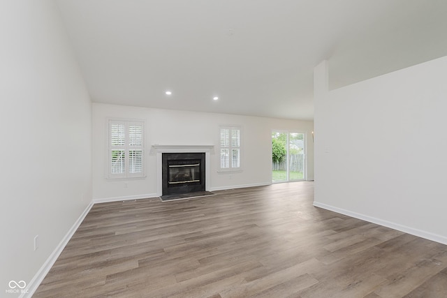 374 Pomona Ct, Greenfield, IN 46140 - unfurnished living room featuring a fireplace with flush hearth, wood finished floors, recessed lighting, and baseboards