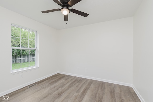 374 Pomona Ct, Greenfield, IN 46140 - unfurnished room with wood finished floors, baseboards, and a ceiling fan