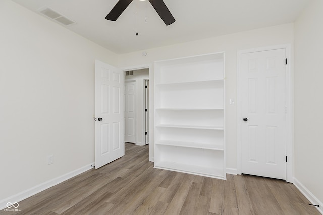 374 Pomona Ct, Greenfield, IN 46140 - unfurnished bedroom featuring wood finished floors, baseboards, and a ceiling fan