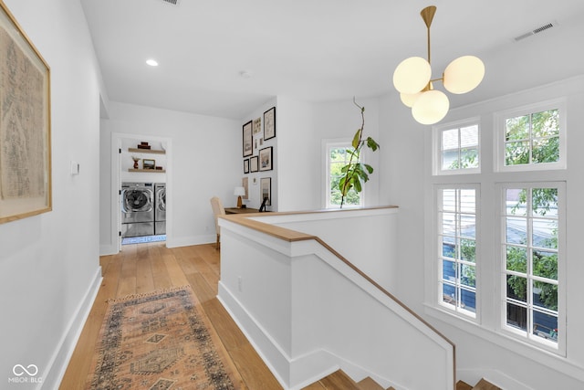 3215 N Pennsylvania St, Indianapolis, IN 46205 - hall with washer and dryer, light wood-type flooring, baseboards, an upstairs landing, and recessed lighting