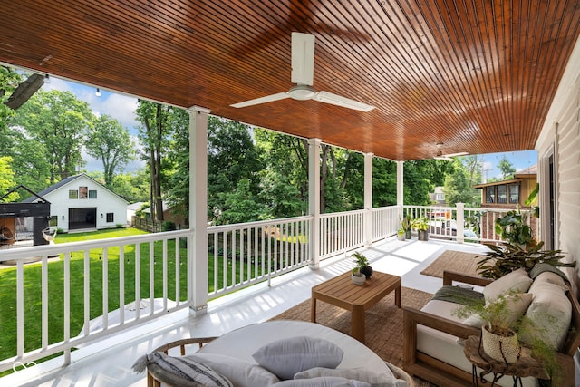 3215 N Pennsylvania St, Indianapolis, IN 46205 - wooden terrace with a lawn, ceiling fan, outdoor lounge area, and view of wooded area