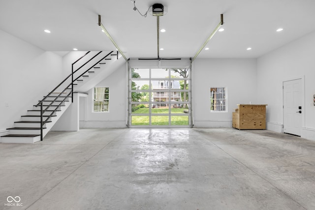 3215 N Pennsylvania St, Indianapolis, IN 46205 - unfurnished living room with stairway, concrete floors, and recessed lighting