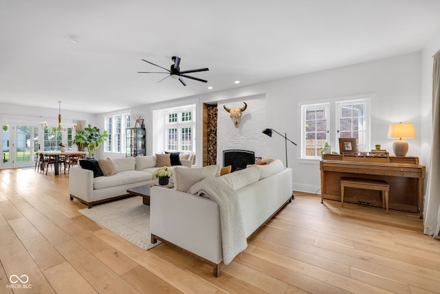 3215 N Pennsylvania St, Indianapolis, IN 46205 - living room featuring a ceiling fan, light wood finished floors, a fireplace, and recessed lighting
