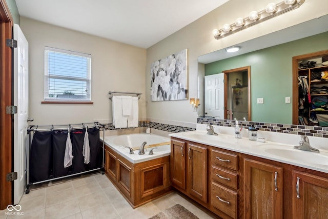 4434 W Windsong Ct, New Palestine, IN 46163 - bathroom featuring tile patterned floors, a garden tub, a spacious closet, double vanity, and decorative backsplash