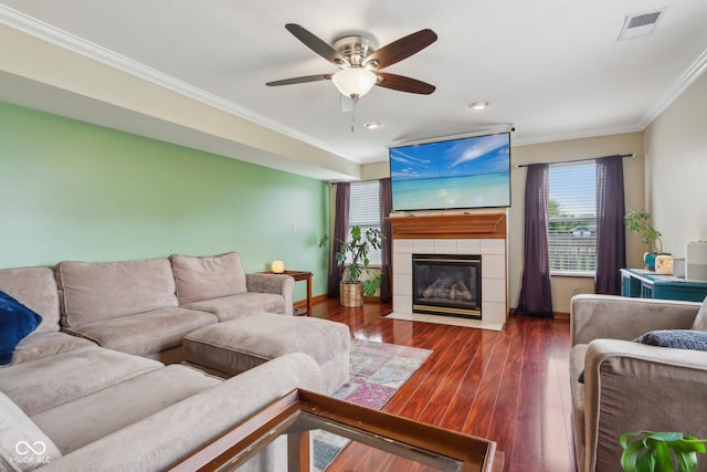 4434 W Windsong Ct, New Palestine, IN 46163 - living room with ornamental molding, a ceiling fan, wood finished floors, a tile fireplace, and baseboards