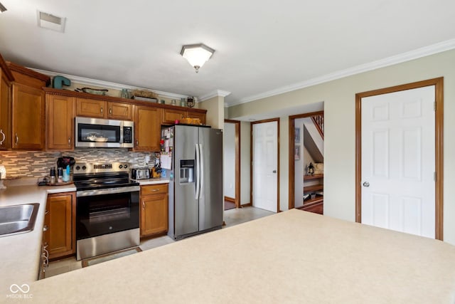 4434 W Windsong Ct, New Palestine, IN 46163 - kitchen featuring appliances with stainless steel finishes, ornamental molding, light countertops, a sink, and decorative backsplash