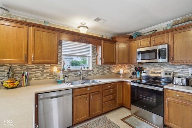 4434 W Windsong Ct, New Palestine, IN 46163 - kitchen featuring appliances with stainless steel finishes, a sink, light countertops, tasteful backsplash, and crown molding