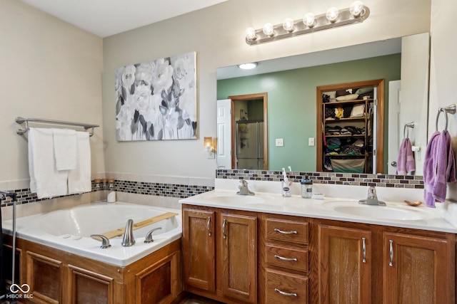4434 W Windsong Ct, New Palestine, IN 46163 - bathroom with a garden tub, double vanity, backsplash, a stall shower, and a walk in closet