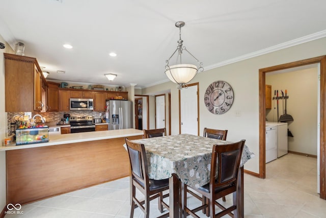 4434 W Windsong Ct, New Palestine, IN 46163 - dining room featuring crown molding, light tile patterned floors, washer and clothes dryer, recessed lighting, and baseboards