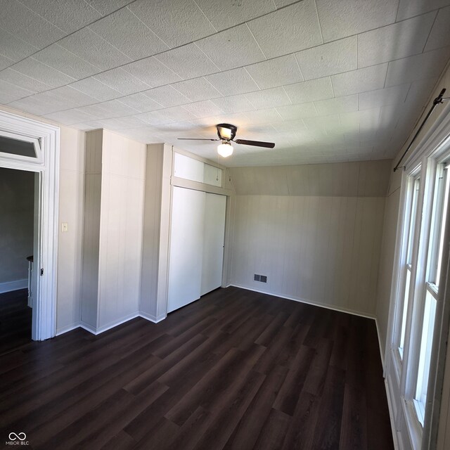 517 E Mechanic St, Brazil, IN 47834 - unfurnished bedroom featuring multiple windows, dark wood finished floors, and baseboards