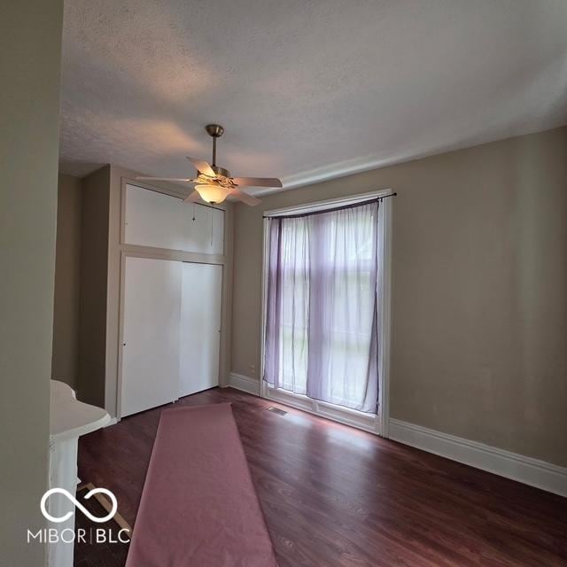 517 E Mechanic St, Brazil, IN 47834 - spare room featuring a ceiling fan, wood finished floors, baseboards, and a textured ceiling