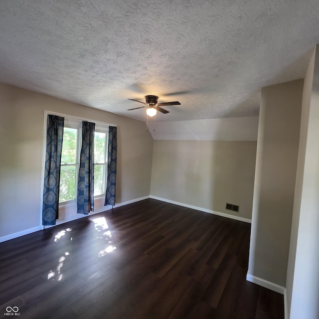 517 E Mechanic St, Brazil, IN 47834 - empty room featuring a textured ceiling, dark wood finished floors, a ceiling fan, and baseboards