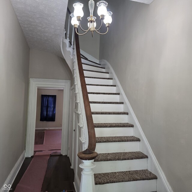 517 E Mechanic St, Brazil, IN 47834 - stairs with baseboards, a chandelier, and a textured ceiling