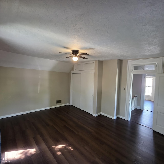 517 E Mechanic St, Brazil, IN 47834 - unfurnished bedroom featuring dark wood-style flooring, a textured ceiling, baseboards, a closet, and ceiling fan