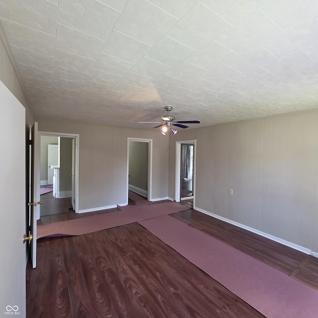 517 E Mechanic St, Brazil, IN 47834 - empty room with dark wood finished floors, baseboards, and ceiling fan
