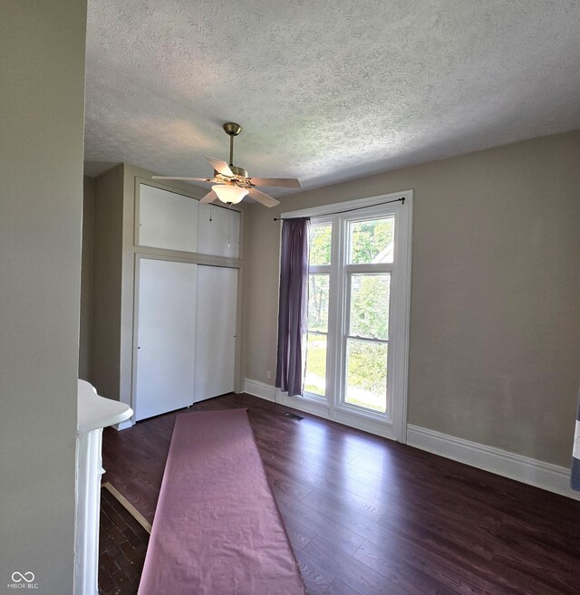 517 E Mechanic St, Brazil, IN 47834 - empty room featuring a textured ceiling, baseboards, ceiling fan, and wood finished floors