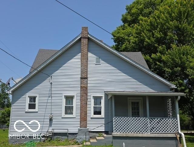 517 E Mechanic St, Brazil, IN 47834 - view of side of property with covered porch and a chimney