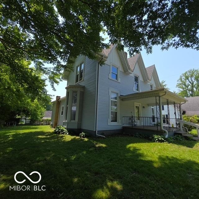 517 E Mechanic St, Brazil, IN 47834 - rear view of property featuring a yard