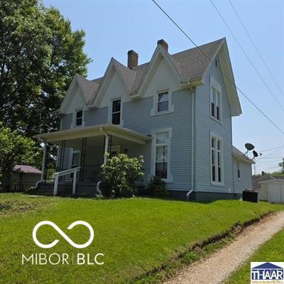 517 E Mechanic St, Brazil, IN 47834 - victorian house featuring a chimney, a front yard, and covered porch