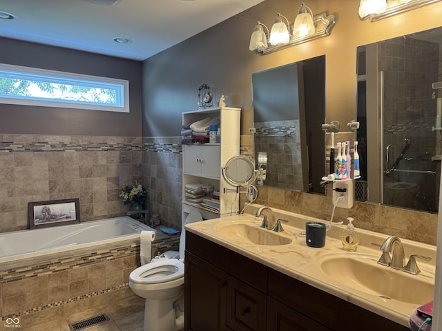 532 N Franklin St, Greensburg, IN 47240 - full bathroom with a garden tub, toilet, double vanity, a shower stall, and tile walls
