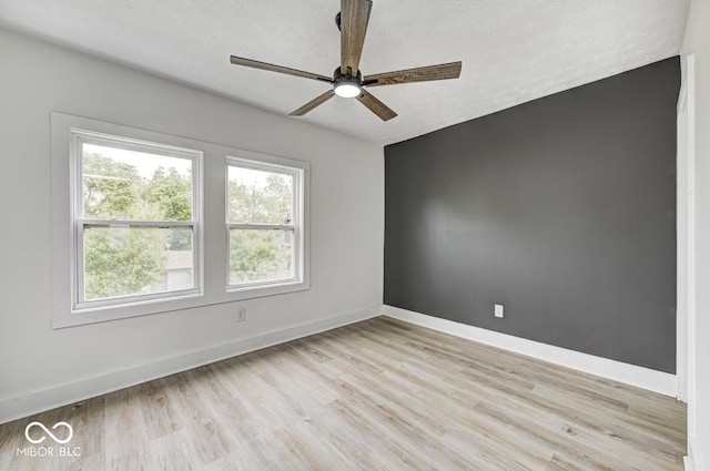 815 E 24th St E, Indianapolis, IN 46205 - unfurnished room featuring a ceiling fan, light wood-type flooring, baseboards, and a textured ceiling