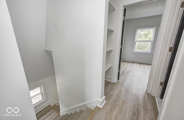 815 E 24th St E, Indianapolis, IN 46205 - corridor with light wood-style floors, an upstairs landing, and baseboards
