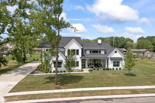 4808 Lakeview Dr, Greenwood, IN 46143 - modern farmhouse with a shingled roof, covered porch, a front lawn, and board and batten siding