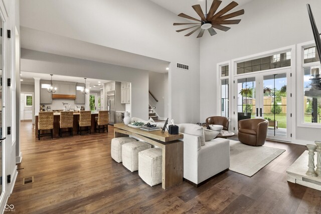 4808 Lakeview Dr, Greenwood, IN 46143 - living area featuring a chandelier, healthy amount of natural light, stairway, a high ceiling, and dark wood finished floors