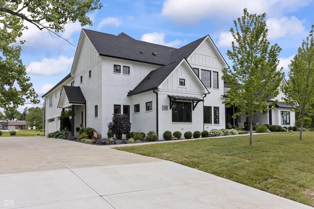 4808 Lakeview Dr, Greenwood, IN 46143 - modern farmhouse style home with board and batten siding, brick siding, a front lawn, driveway, and roof with shingles