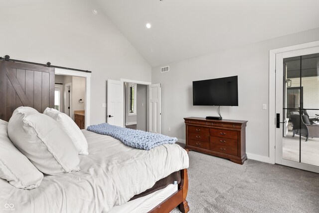 4808 Lakeview Dr, Greenwood, IN 46143 - carpeted bedroom with high vaulted ceiling, baseboards, a barn door, ensuite bathroom, and recessed lighting