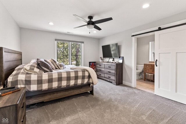 4808 Lakeview Dr, Greenwood, IN 46143 - bedroom featuring a barn door, light colored carpet, recessed lighting, connected bathroom, and ceiling fan