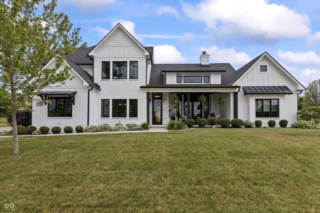 4808 Lakeview Dr, Greenwood, IN 46143 - modern inspired farmhouse featuring board and batten siding, a front lawn, a chimney, and roof with shingles