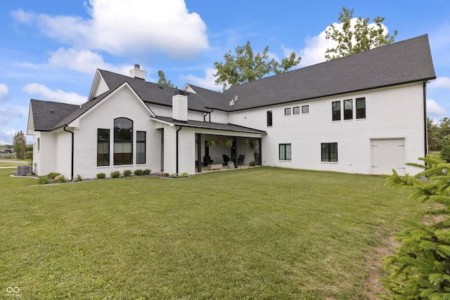 4808 Lakeview Dr, Greenwood, IN 46143 - back of house featuring a chimney, a yard, roof with shingles, a patio, and central AC