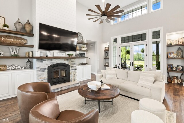 4808 Lakeview Dr, Greenwood, IN 46143 - living area featuring dark wood-style flooring, a ceiling fan, a towering ceiling, and a fireplace