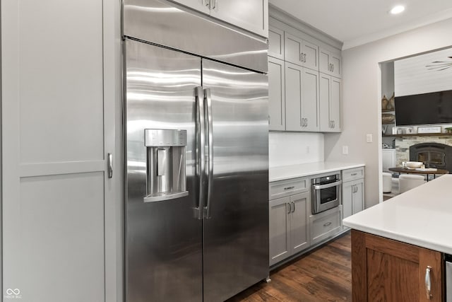 4808 Lakeview Dr, Greenwood, IN 46143 - kitchen featuring appliances with stainless steel finishes, dark wood finished floors, light countertops, gray cabinets, and a fireplace