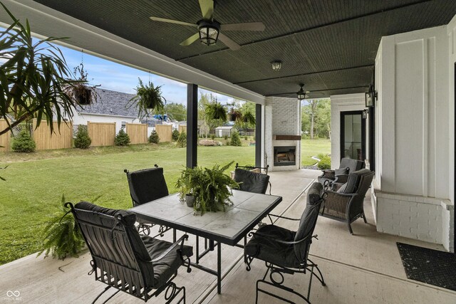 4808 Lakeview Dr, Greenwood, IN 46143 - view of patio featuring a fireplace, a ceiling fan, and outdoor dining area