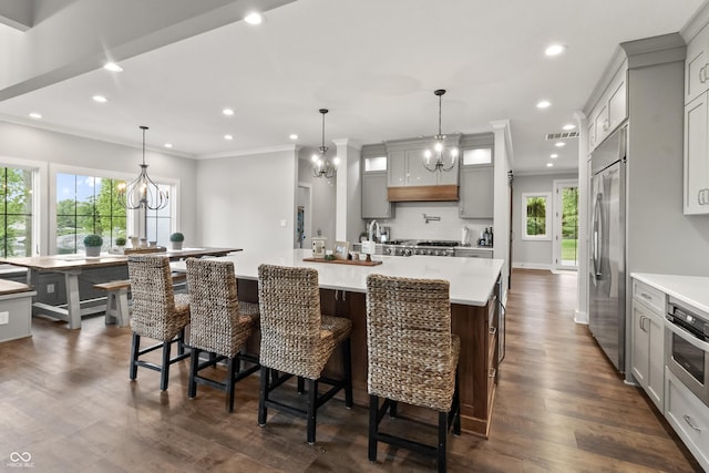 4808 Lakeview Dr, Greenwood, IN 46143 - kitchen featuring stainless steel appliances, a large island, light countertops, a chandelier, and ornamental molding