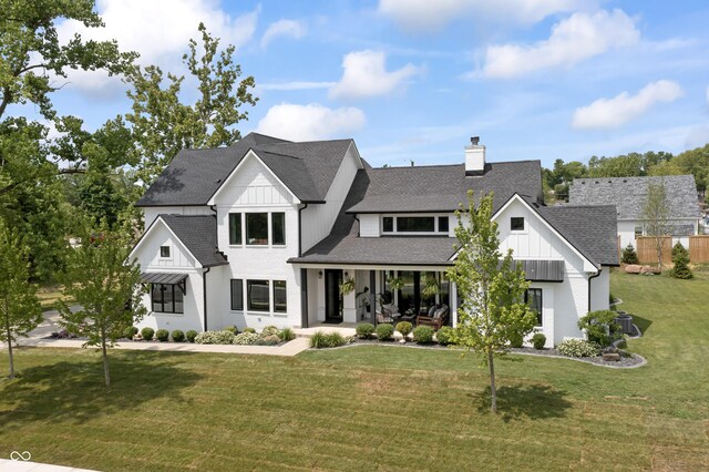 4808 Lakeview Dr, Greenwood, IN 46143 - modern farmhouse style home featuring roof with shingles, a chimney, a porch, board and batten siding, and a front lawn
