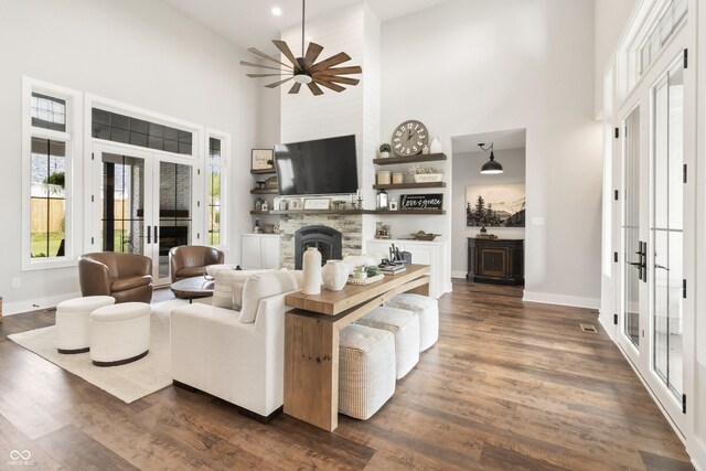 4808 Lakeview Dr, Greenwood, IN 46143 - living room featuring a high ceiling, french doors, baseboards, a stone fireplace, and dark wood-type flooring