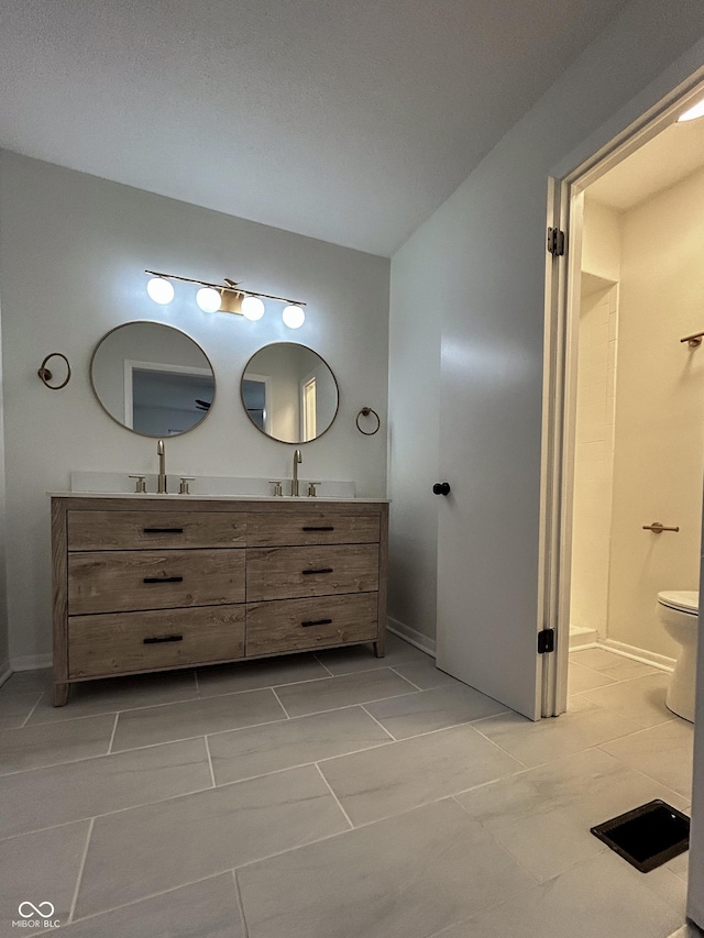 1653 Wade St, Indianapolis, IN 46203 - full bathroom featuring double vanity, baseboards, toilet, and tile patterned floors