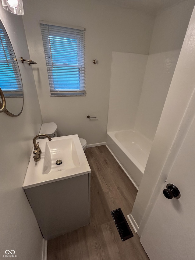 1653 Wade St, Indianapolis, IN 46203 - full bath featuring toilet, wood finished floors, and vanity