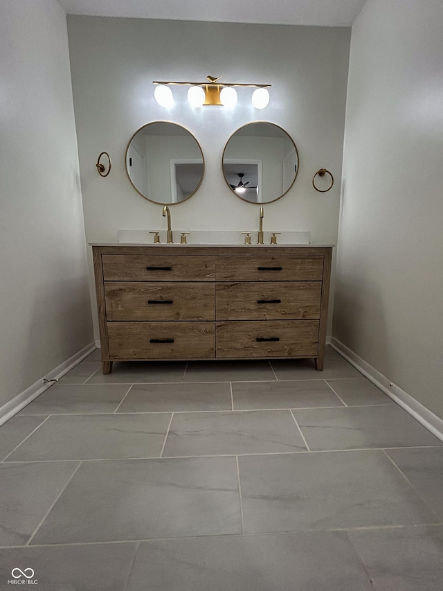 1653 Wade St, Indianapolis, IN 46203 - bathroom featuring double vanity and baseboards