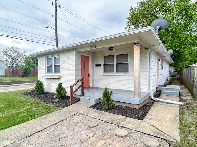 1653 Wade St, Indianapolis, IN 46203 - ranch-style home with brick siding and a porch